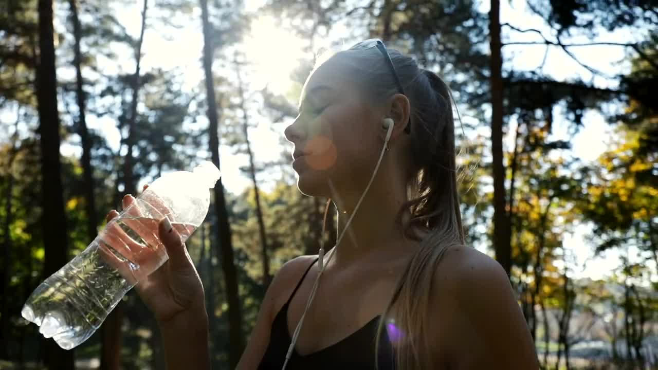 Download Stock Video Fitness Woman Drinking Water During Her Training Live Wallpaper For PC