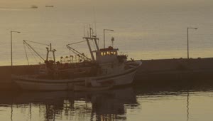 Stock Video Fishing Boat Anchored In A Harbor Town Live Wallpaper For PC