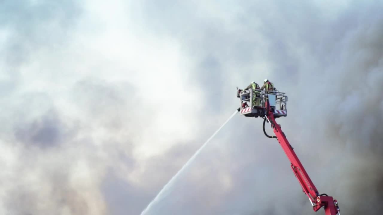 Download Stock Video Firefighters On A Crane Putting Out A Fire Live Wallpaper For PC