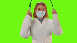 Stock Video Female Doctor With Mask On A Green Background Live Wallpaper For PC