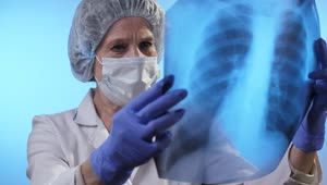 Stock Video Female Doctor Looking At An X Ray Of Lungs Live Wallpaper For PC