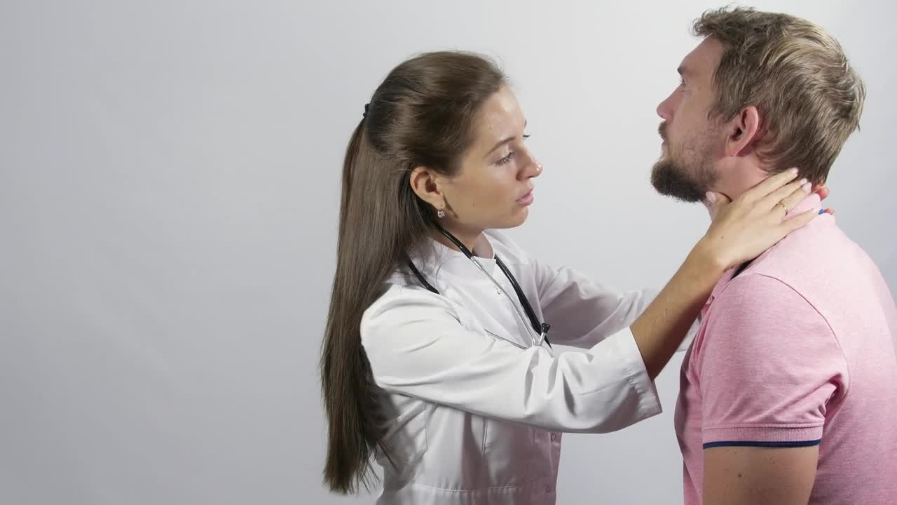 Download Stock Video Female Doctor Inspecting A Young Man Live Wallpaper For PC