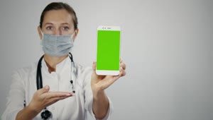 Stock Video Female Doctor Displaying Mobile With Green Screen Live Wallpaper For PC