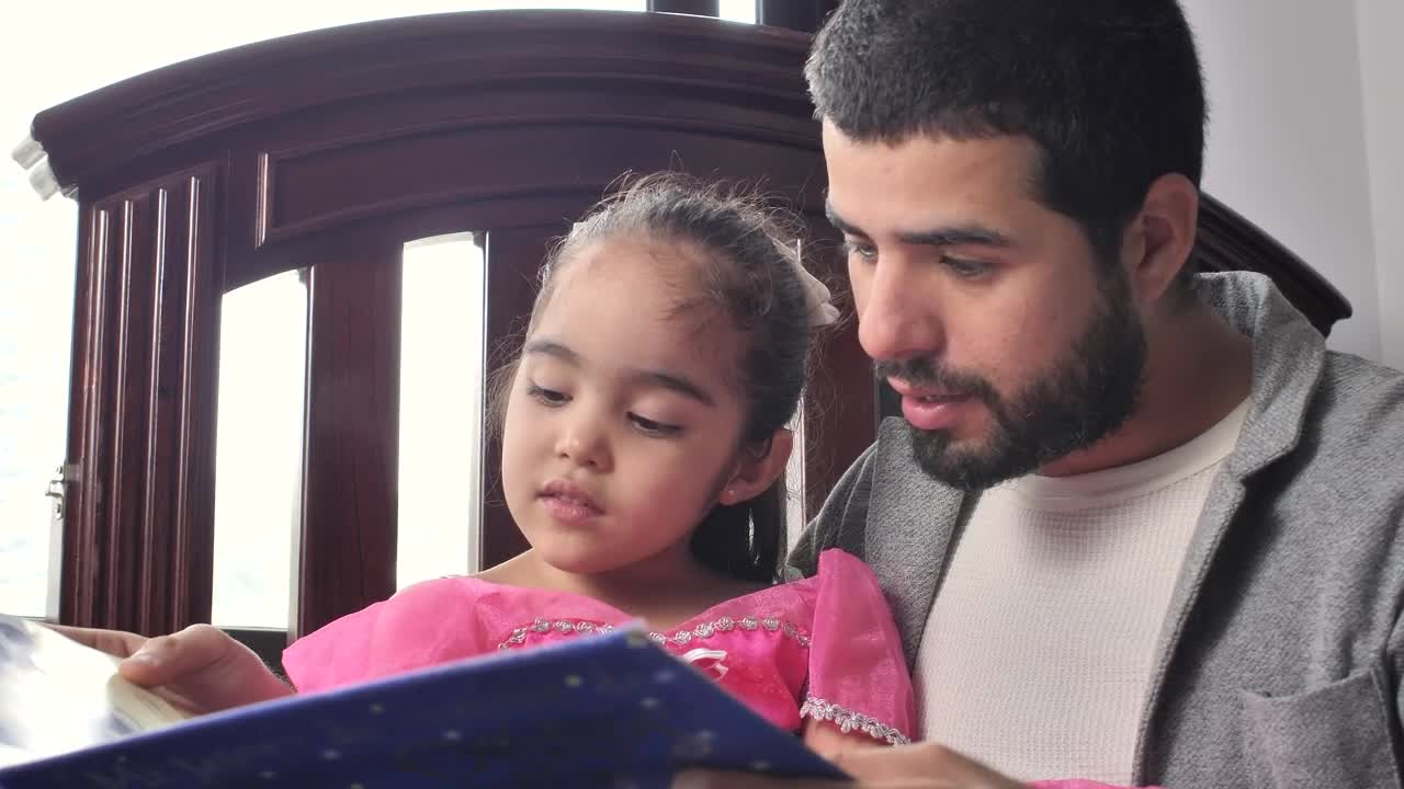 Download Stock Video Father Reading A Story To His Daughter In His Arms Live Wallpaper For PC