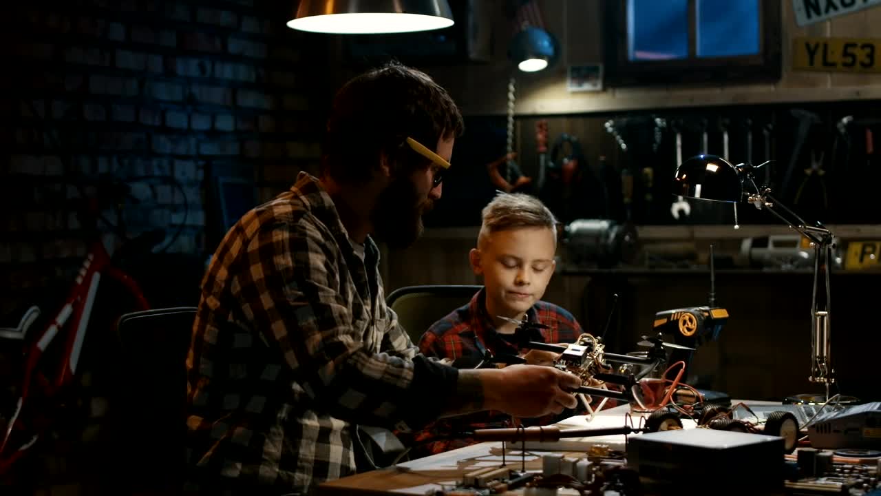 Download Stock Video Father And Son Repairing A Drone Live Wallpaper For PC