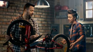 Stock Video Father And Son Repairing A Wheel Of A Bike Live Wallpaper For PC