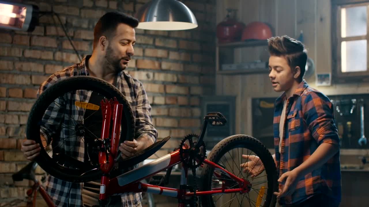 Download Stock Video Father And Son Repairing A Wheel Of A Bike Live Wallpaper For PC