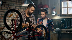 Stock Video Father And Son Repairing A Bike With Tutorial Live Wallpaper For PC