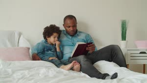 Stock Video Father And Son Reading A Book Together Live Wallpaper For PC