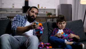 Stock Video Father And Son On A Sofa Playing With Legos Live Wallpaper For PC