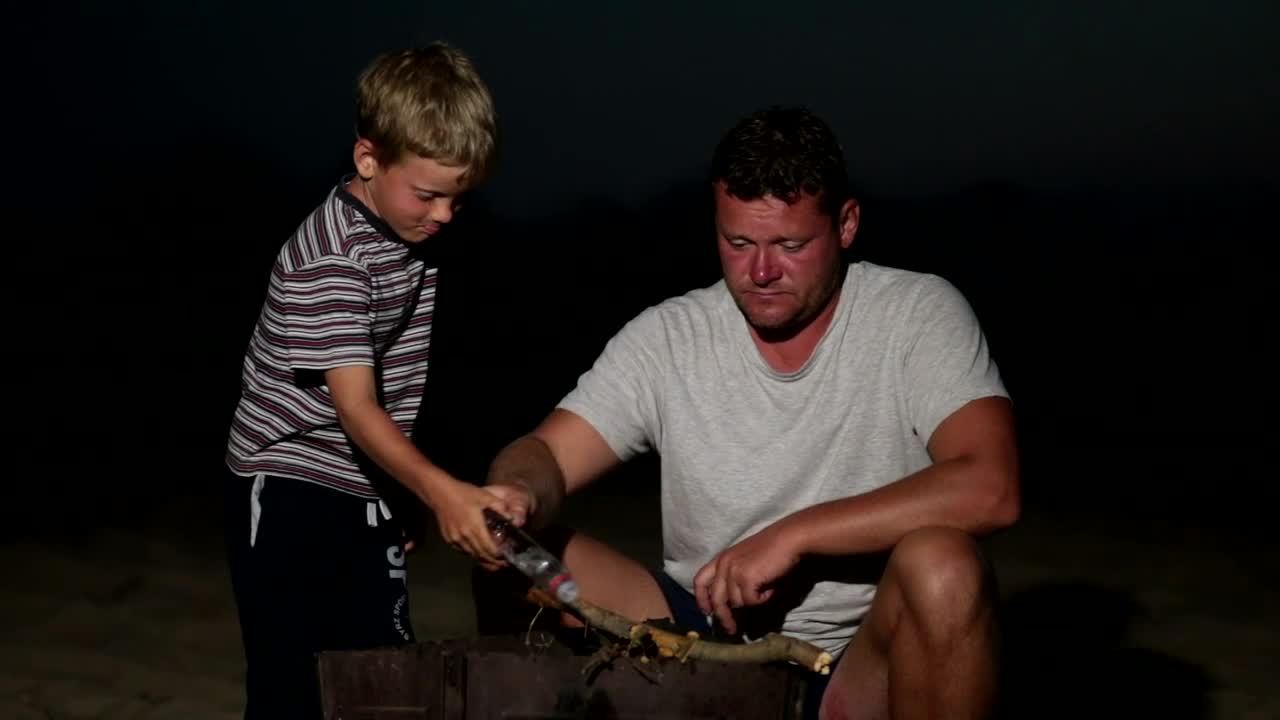 Download Stock Video Father And Son Lighting A Campfire At Night Live Wallpaper For PC