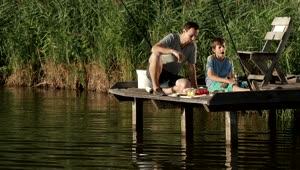 Stock Video Father And Son Having Lunch While Fishing Live Wallpaper For PC