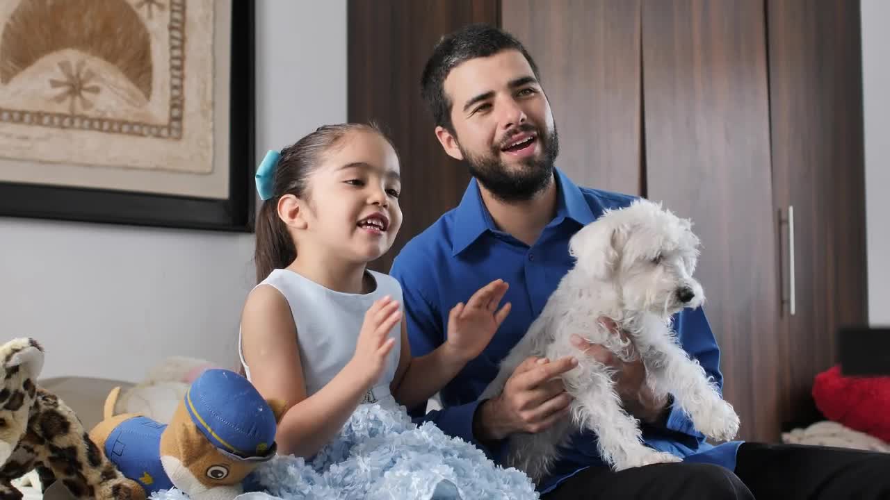 Download Stock Video Father And Daughter Together Watching Television With Their Little Dog Live Wallpaper For PC