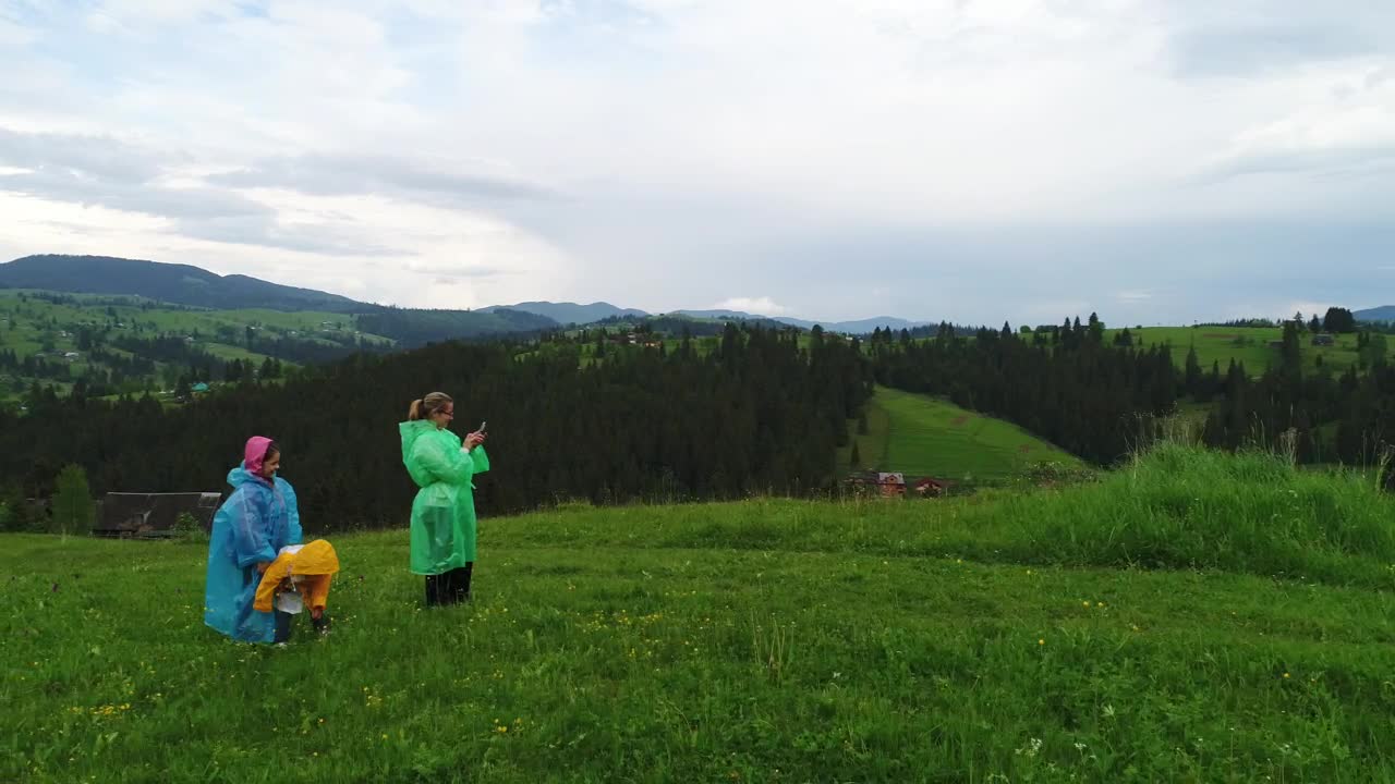 Download Stock Video Family Wearing Raincoats Taking Selfies In Nature Live Wallpaper For PC