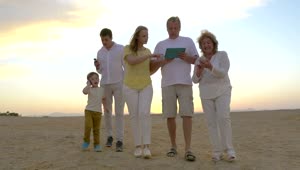 Stock Video Family Walking Along The Beach With A Tablet Live Wallpaper For PC