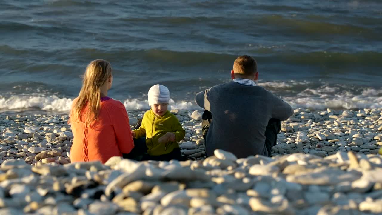 Download Stock Video Family Sitting On A Pebble Beach Live Wallpaper For PC