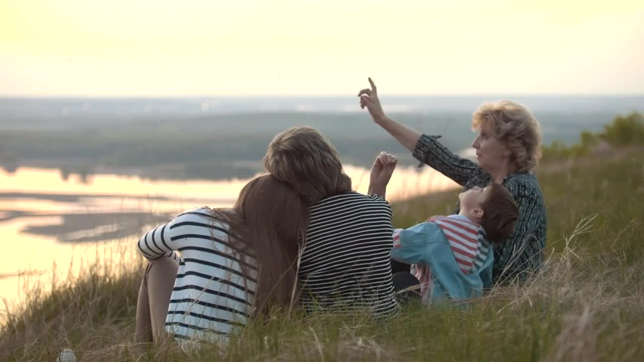 Download Stock Video Family Sitting On A Hill Watching The Nature Live Wallpaper For PC