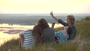 Stock Video Family Sitting On A Hill Watching The Nature Live Wallpaper For PC