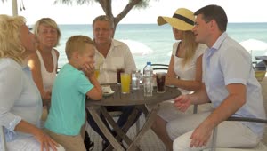 Stock Video Family Sitting At A Beach Table Live Wallpaper For PC