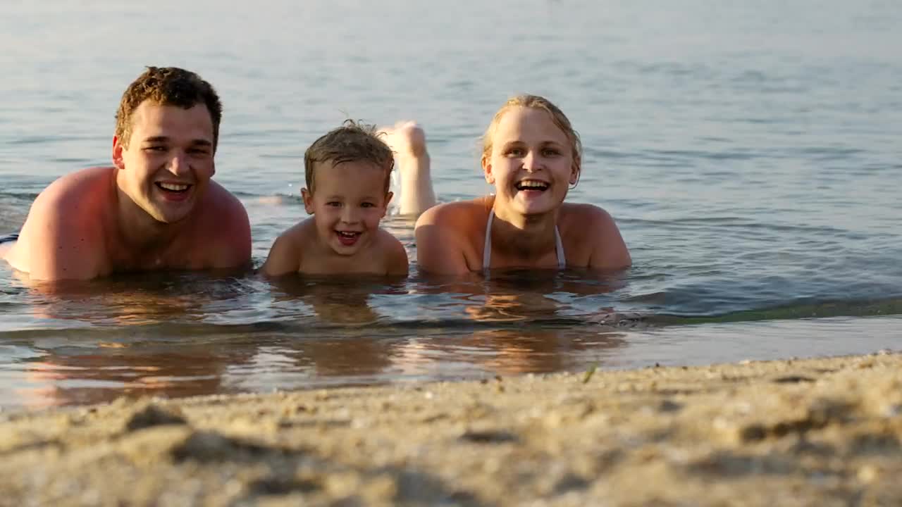 Download Stock Video Family Laughing While Laying In The Ocean Live Wallpaper For PC