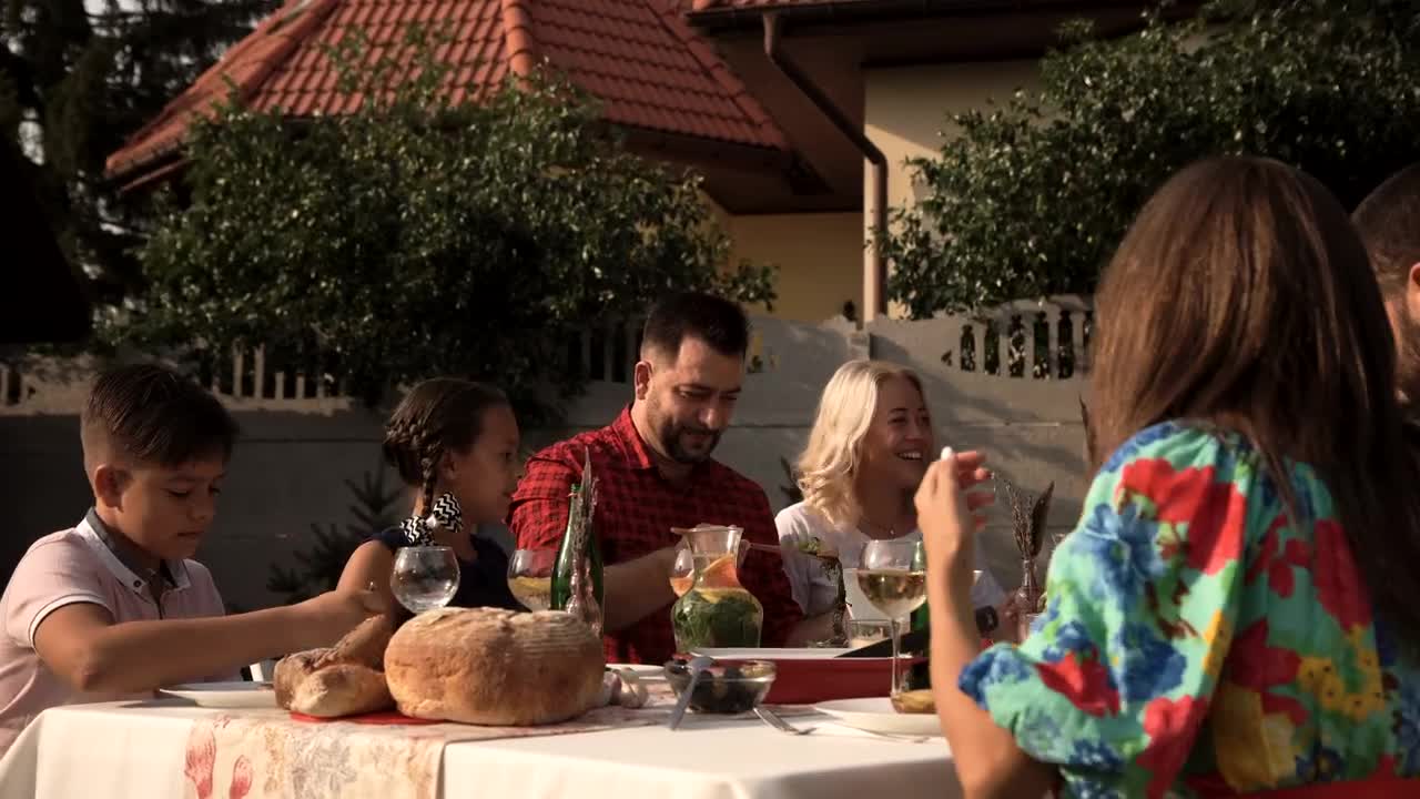 Download Stock Video Family Having Dinner In The Garden On A Sunny Day Live Wallpaper For PC