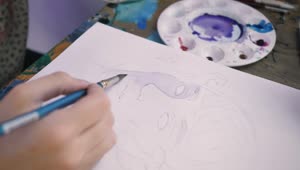 Stock Video Hand Of An Artist Painting A Face With Watercolors Live Wallpaper For PC
