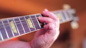 Stock Video Hand Of A Man Playing Chords On A Guitar Live Wallpaper For PC