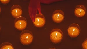 Stock Video Hand Of A Lady Arranging Burning Candles Live Wallpaper For PC
