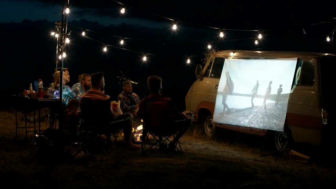 Download Stock Video Group Of Friends Watching A Movie With A Projector Live Wallpaper For PC
