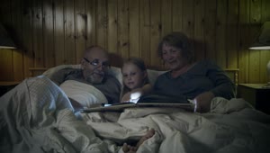 Stock Video Grandparents Reading A Story To Their Grandchild Live Wallpaper For PC