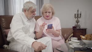 Stock Video Grandmother Teaches Her Husband How To Use A Phone Live Wallpaper For PC