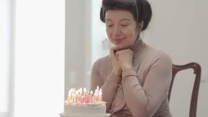 Stock Video Grandmother On Her Birthday With A Cake With Candles Live Wallpaper For PC