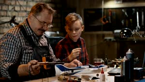 Stock Video Grandfather And Grandson Repairing The Toy Plane Live Wallpaper For PC