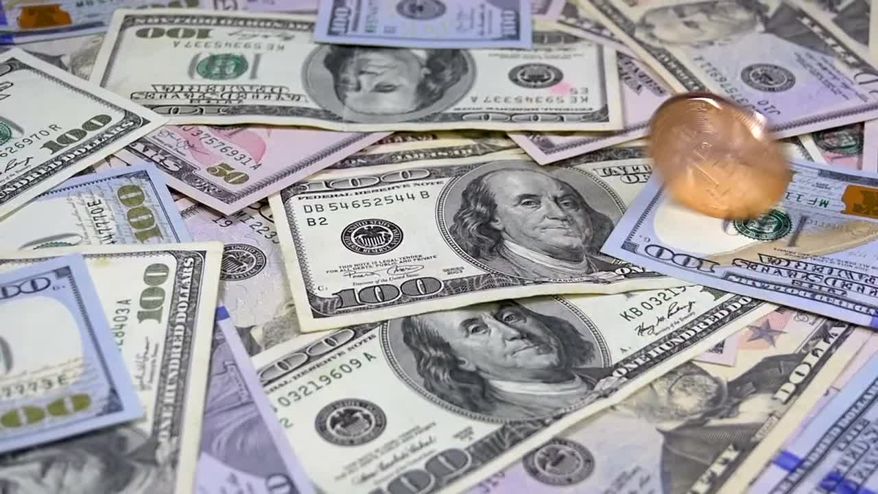 Download Stock Video Golden Bitcoin Rotating Over Dollar Bills Live Wallpaper For PC