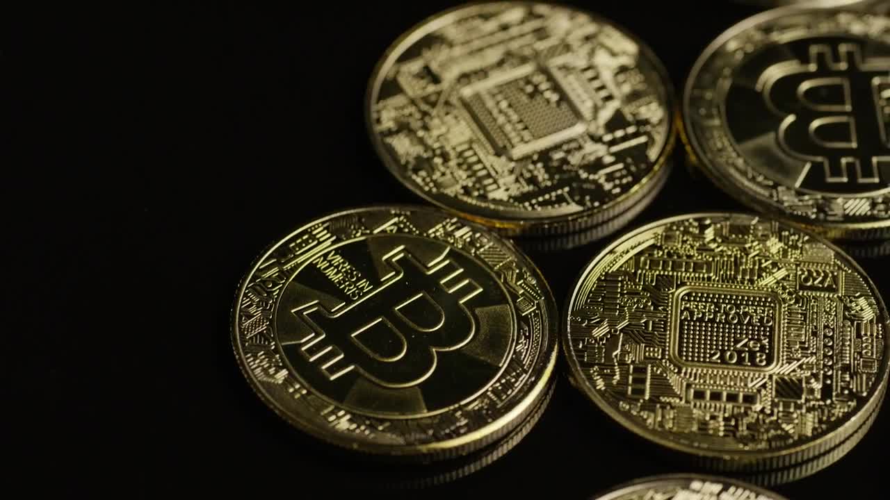 Download Stock Video Golden Bitcoin Coins Rotating On A Black Surface Live Wallpaper For PC