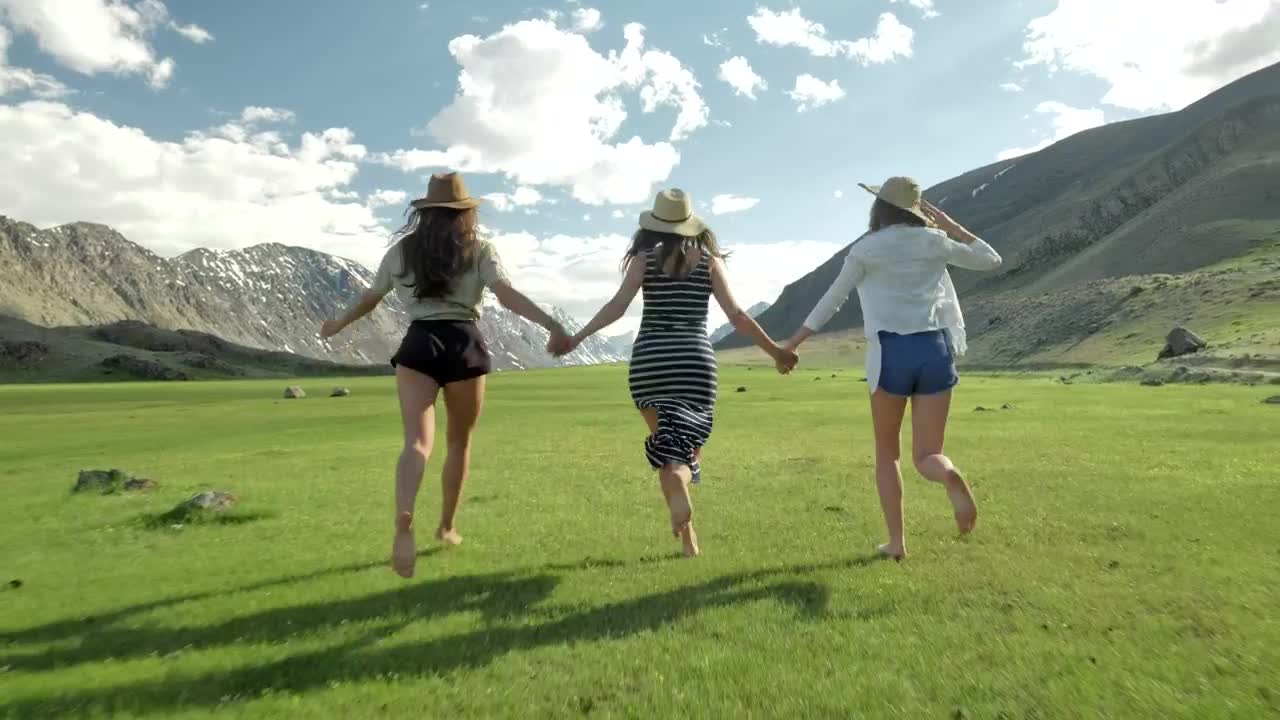 Download Stock Video Girls Holding Hands And Running Through Open Mountain Landscape Live Wallpaper For PC
