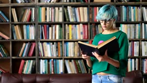 Download Stock Video Girl With Glasses Reading A Book In A Library Live Wallpaper For PC