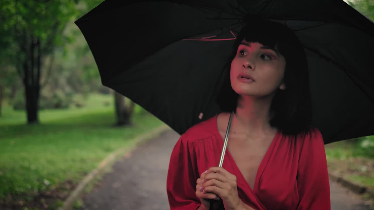 Download Stock Video Girl With An Umbrella Walking Through A Park Live Wallpaper For PC