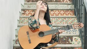 Stock Video Girl Sitting On A Stairs Starts To Play Her Guitar Live Wallpaper For PC