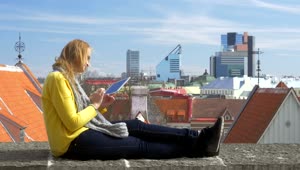 Stock Video Girl Sitting On A Rooftop With Her Tablet Live Wallpaper For PC