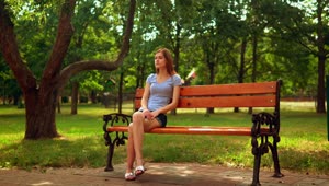 Stock Video Girl Sitting On A Bench Waiting For Someone Live Wallpaper For PC
