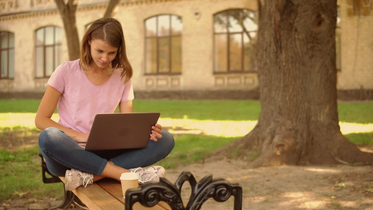 Download Stock Video Girl Sitting In A Garden Typing On A Laptop Live Wallpaper For PC