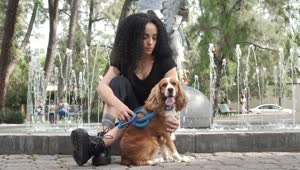 Stock Video Girl Sitting At A Fountain With Her Dog Aside Live Wallpaper For PC
