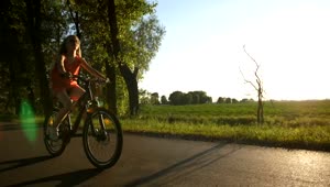 Stock Video Girl Riding A Bike On A Warm Evening Live Wallpaper For PC