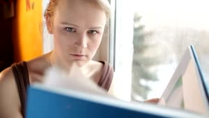Stock Video Girl Reading A Large Book By The Window  Smal Live Wallpaper For PC