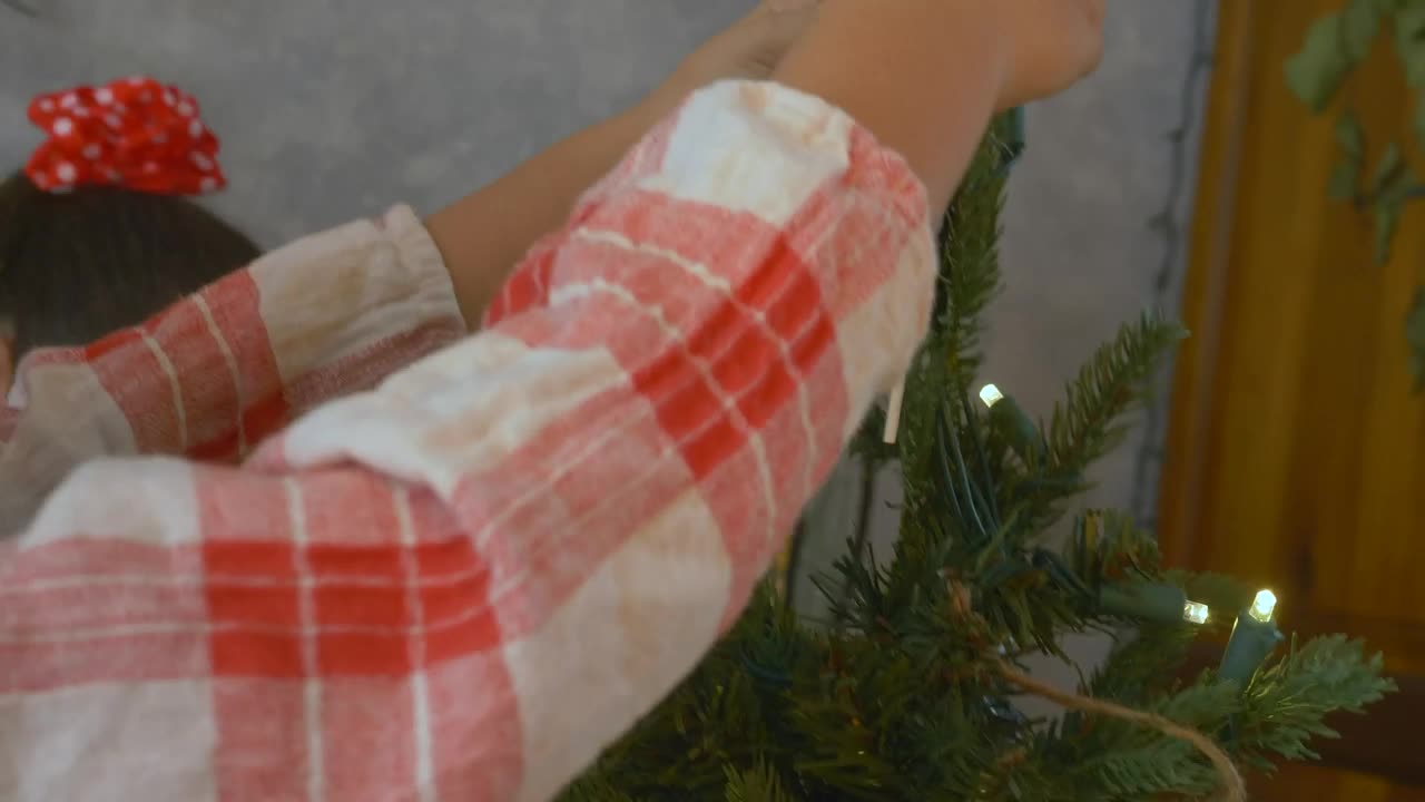 Download Stock Video Girl Putting The Star Of A Christmas Tree Live Wallpaper For PC