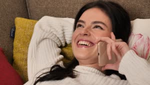 Stock Video Girl On A Sofa Laughing During A Phone Call Live Wallpaper For PC
