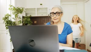 Stock Video Girl Greets Grandma While She Works On Laptop Live Wallpaper For PC