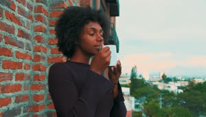Stock Video Girl Enjoying The Smell Of Her Coffee Standing On A Live Wallpaper For PC