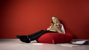 Stock Video Girl Enjoys Distance Learning In Beanbag Chair Live Wallpaper For PC